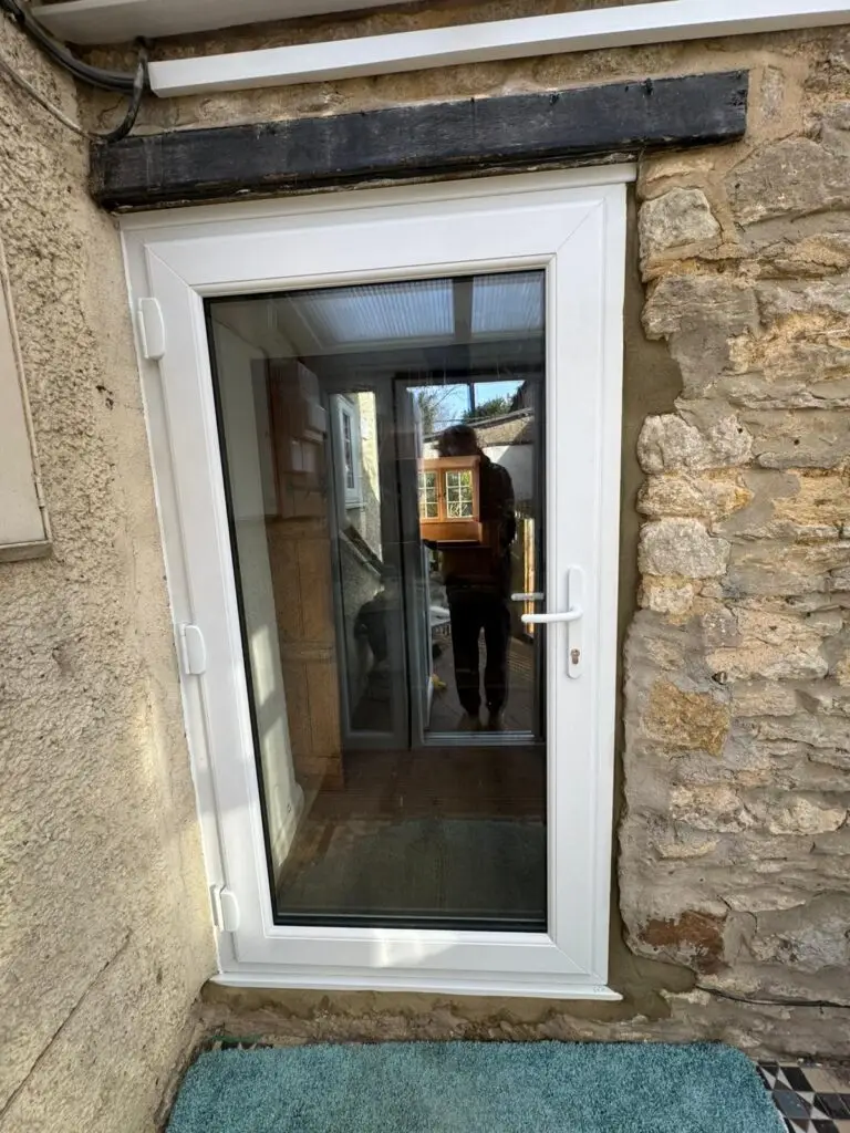Panelled uPVC door with solid lower panels and optional glazed top section