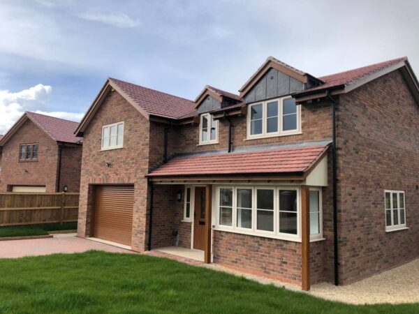 hite uPVC casement windows fitted to a brick house exterior