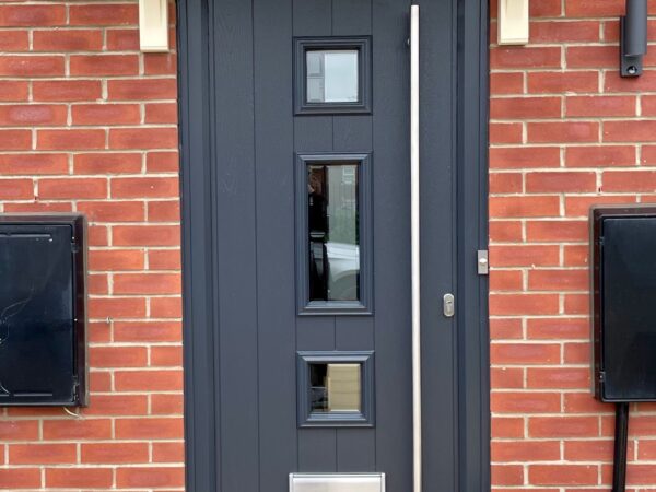 Traditional style composite front door with side panels and chrome hardware