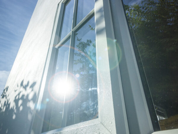 Close-up of agate grey chamfered uPVC casement window frame and hardware