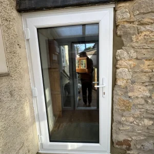 Panelled uPVC door with solid lower panels and optional glazed top section