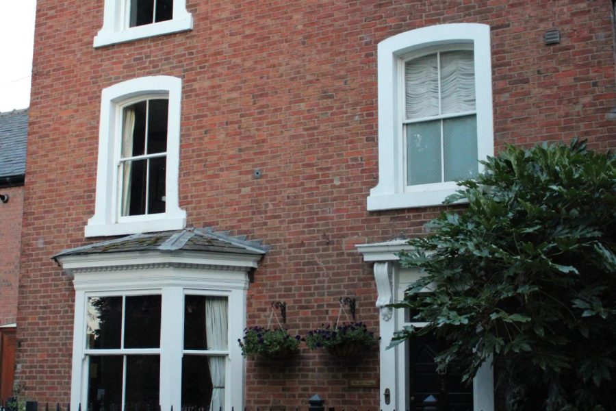 uPVC vertical sliding sash window with upper sash open for ventilation