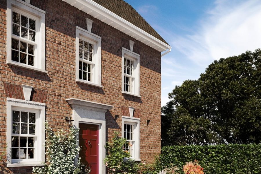 hite uPVC vertical sliding sash window with Georgian bars on a period home exterior